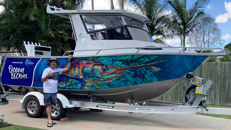 an image of paul shaw in front of a boat featuring a marlin boat wrap