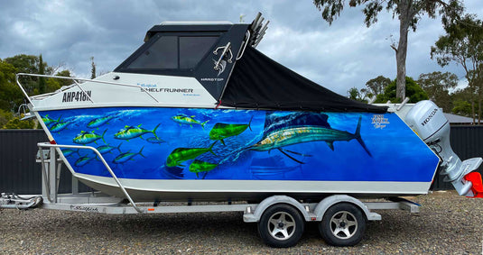 Boat with Sailfish-themed wrap on a trailer.